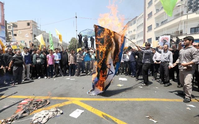 Des manifestants iraniens brûlent un drapeau israélien lors d'une manifestation pour marquer la journée internationale de Al Qods (Jérusalem) à Téhéran le 10 juillet 2015. (Crédit : AFP / ATTA KENARE) Des manifestants iraniens brûlent un drapeau israélien lors d'une manifestation pour marquer la journée internationale de Al Qods (Jérusalem) à Téhéran le 10 juillet 2015. (Crédit : AFP / ATTA KENARE)