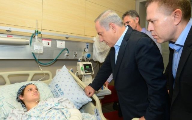 Le Premier ministre Benjamin Netanyahu et le ministre de la Sécurité intérieure rendent visite à Adèle Benet et à son bébé, qui ont été blessés  le 3 octobre 2015 dans un attentat terroriste dans la Vieille Ville de Jérusalem au cours duquel Aharon Benet a été assassiné, à l'hôpital Hadassah Ein Kerem à Jérusalem, le 5 octobre 2015 (Crédit : Kobi Gideon / GPO)