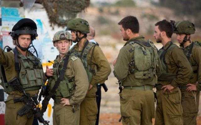 Des soldats israéliens sur le site de l'attaque terroriste de mardi près du carrefour Gush Etzion, où un Palestinien a percuté sa voiture dans des piétons à un arrêt de bus et a ensuite tenté de les poignarder, le 20 octobre 2015 (Crédit photo: Yonatan Sindel / Flash90)