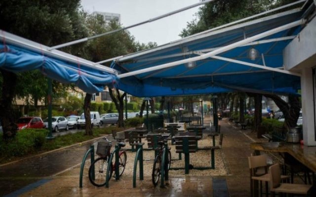 Chaises vides dans un café en plein air sur le boulevard Ben Gourion alors qu'un orage s'abat sur Tel Aviv, le 25 octobre 2015 (Crédit photo: Ben Kelmer / Flash90) Chaises vides dans un café en plein air sur le boulevard Ben Gourion alors qu'un orage s'abat sur Tel Aviv, le 25 octobre 2015 (Crédit photo: Ben Kelmer / Flash90)