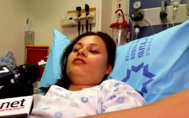 Hisouri Tepalya, une femme népalaise blessée dans une attaque terroriste le 29 novembre 2015, parlant aux journalistes de son lit d'hôpital (Crédit : Capture d'écran : Ynet)