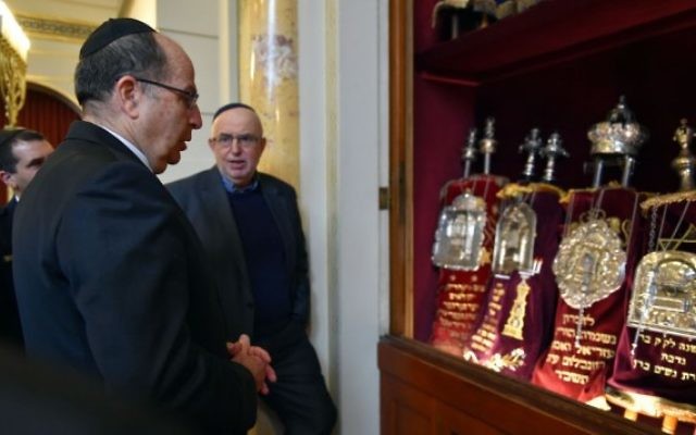 Le ministre de la Défense Moshe Yaalon devant des rouleaux de la Torah à Bern, en Suisse, le 10 février 2016. (Crédit : Ariel Hermoni/Defense Ministry)