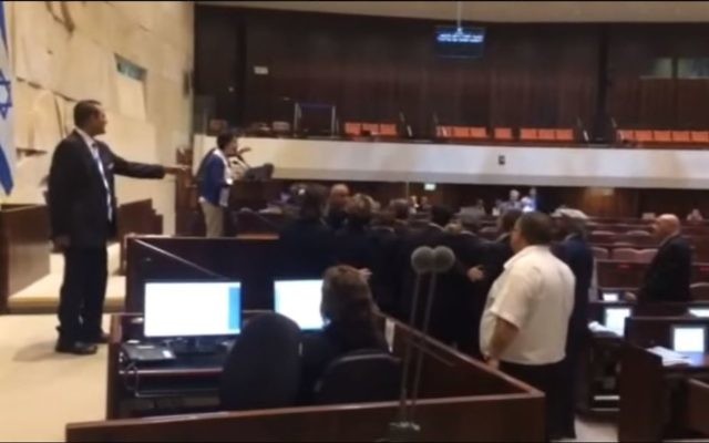 La députée Hanin Zoabi (au centre), de la Liste Arabe Unie, confronte ses camarades parlementaires en assemblée de la Knesset après ses remarques sur l'accord de réconciliation entre la Turquie et Israël, le 29 juin 2016. (Crédits  : capture d'écran YouTube)