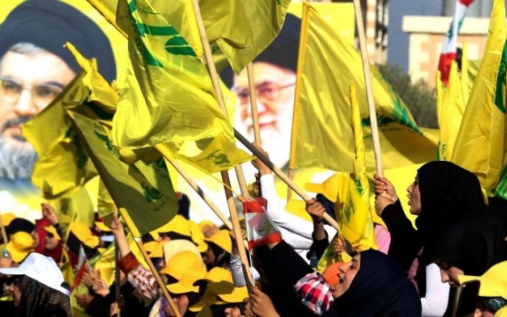 Des femmes agitent des drapeaux libanais ou du groupe terroriste chiite du Hezbollah devant des portraits du guide suprême iranien, l'ayatollah Ali Khamenei (à droite) et le chef du Hezbollah Hassan Nasrallah, pendant un discours de ce dernier commémorant les dix ans de la deuxième guerre du Liban, à Bint Jbeil, le 13 août 2016. (Crédit : AFP/Mahmoud Zayyat) Des femmes agitent des drapeaux libanais ou du groupe terroriste chiite du Hezbollah devant des portraits du guide suprême iranien, l'ayatollah Ali Khamenei (à droite) et le chef du Hezbollah Hassan Nasrallah, pendant un discours de ce dernier commémorant les dix ans de la deuxième guerre du Liban, à Bint Jbeil, le 13 août 2016. (Crédit : AFP/Mahmoud Zayyat)