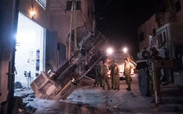 Les troupes de l'armée en train de sortir des machines à fabriquer des armes d'un atelier en Cisjordanie, le 1er Août 2016 (Crédit : Porte-parole de l'armée) Les troupes de l'armée en train de sortir des machines à fabriquer des armes d'un atelier en Cisjordanie, le 1er Août 2016 (Crédit : Porte-parole de l'armée)