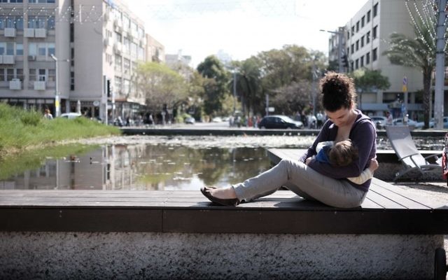 Une mère allaite son enfant (Crédit : Tomer Neuberg/Flash90)