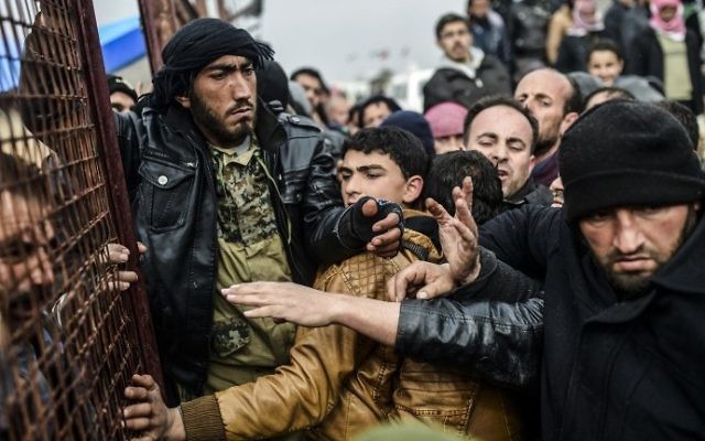 Les réfugiés se bousculant les uns et les autres en attendant des tentes tandis que les Syriens fuient la ville d'Alep, le 6 février 2016 à Bab al-Salama, près de la ville d'Azaz, au nord de la Syrie (Crédit : Bulent Kilic / AFP)