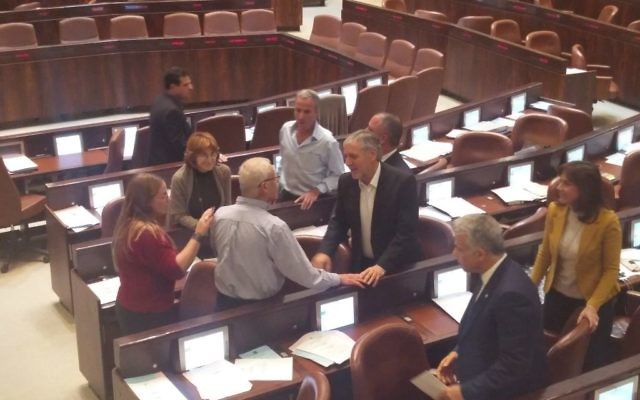 Le député du Likud Benny Begin, en chemise bleue, félicité par des députés de l'opposition à la Knesset, le 7 décembre 2016. (Crédit : Raoul Wootliff/Times of Israel)