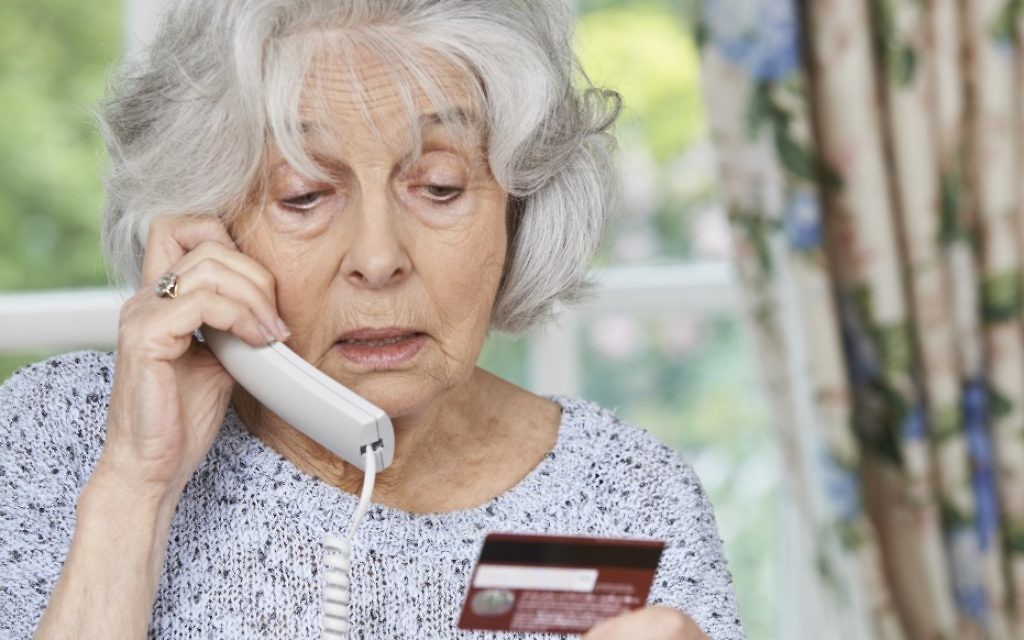 Une femme âgée donne son numéro de carte de crédit au téléphone. Illustration. (Crédit :  Istock Highway-starz photography)