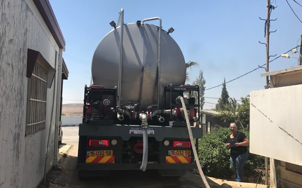 Yael Hashash, directrice de l'implantation de Migdalim contemple la citerne qui approvisionne son implantation en eau, le 4 juin 2017. (Crédit : Jacob Magid/Times of Israel) Yael Hashash, directrice de l'implantation de Migdalim contemple la citerne qui approvisionne son implantation en eau, le 4 juin 2017. (Crédit : Jacob Magid/Times of Israel)