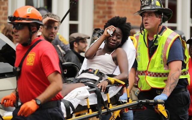 Secouristes sur les lieux d'une attaque à la voiture bélier contre des manifestants anti-racistes à Charlottesville, en Virginie, le 12 août 2017. (Crédit : Chip Somodevilla/Getty Images/AFP) Secouristes sur les lieux d'une attaque à la voiture bélier contre des manifestants anti-racistes à Charlottesville, en Virginie, le 12 août 2017. (Crédit : Chip Somodevilla/Getty Images/AFP)