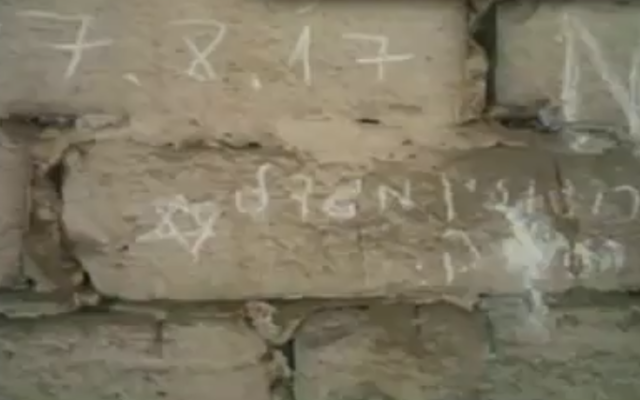 Un graffiti portant le nom du lycée Rogozin de Migdal Haemek, ville du nord d'Israël, découvert au camp d'extermination d'Auschwitz en septembre 2017. (Crédit : capture d'écran Deuxième chaîne) Un graffiti portant le nom du lycée Rogozin de Migdal Haemek, ville du nord d'Israël, découvert au camp d'extermination d'Auschwitz en septembre 2017. (Crédit : capture d'écran Deuxième chaîne)