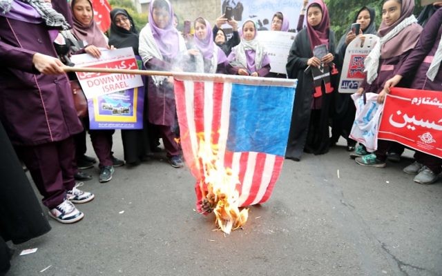 Des Iraniens brûlent un drapeau américain le 4 novembre 2017 à Téhéran aux cris de "Mort à l'Amérique" (Crédit : AFP/ATTA KENARE)