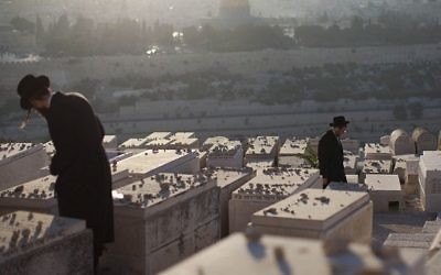 Des Juifs ultra-orthodoxes sur les tombes du mont des Oliviers (Crédit :  Yonatan Sindel/Flash90)