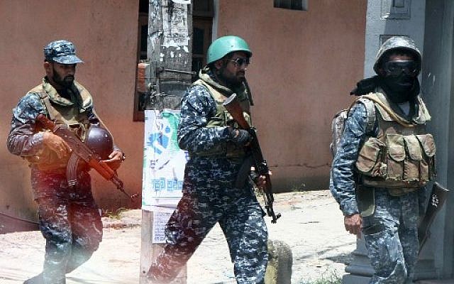 Des soldats de l'armée sri-lankaise patrouillant dans les rues de Digana, dans la banlieue de Kandy, le 8 mars 2018 (AFP PHOTO) Des soldats de l'armée sri-lankaise patrouillant dans les rues de Digana, dans la banlieue de Kandy, le 8 mars 2018 (AFP PHOTO)