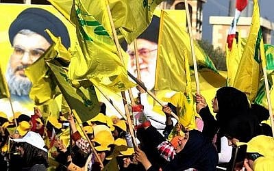 Des femmes brandissent des drapeaux
libanais et du Hezbollah devant les portraits du dirigeant suprême iranien, l'ayatollah Ali Khamenei et du dirigeant du Hezbollah Hassan Nasrallah, dans la ville de Bint Jbeil, au sud du Liban, le 13 août 2016. (AFP Photo / Mahmoud Zayyat)