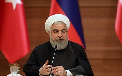 Le président iranien Hassan Rouhani durant une conférence de presse conjointe avec les leaders de Turquie et de Russie lors d'un sommet tripartite sur la Syrie à Ankara, le 4 avril 2018 (Crédit : AFP PHOTO / ADEM ALTAN)