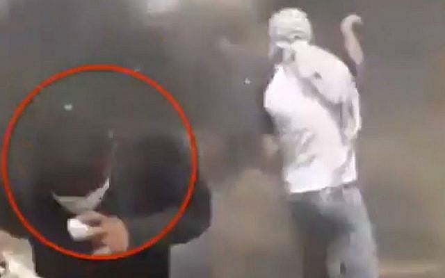 Capture d'écran d'une vidéo montrant un émeutier palestinien blessant accidentellement un manifestant avec son lance-pierre alors qu'il visait les forces de sécurité israéliennes à la frontière avec la bande de Gaza, 27 avril 2018. (Twitter) Capture d'écran d'une vidéo montrant un émeutier palestinien blessant accidentellement un manifestant avec son lance-pierre alors qu'il visait les forces de sécurité israéliennes à la frontière avec la bande de Gaza, 27 avril 2018. (Twitter)