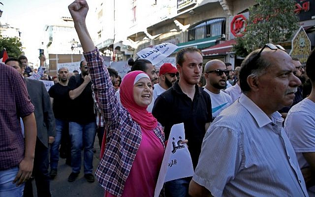Les Palestiniens participent à une manifestation appelant à la levée des sanctions contre la bande de Gaza, dans la ville de Ramallah en Cisjordanie, le 23 juin 2018. (Crédit : AFP / ABBAS MOMANI) Les Palestiniens participent à une manifestation appelant à la levée des sanctions contre la bande de Gaza, dans la ville de Ramallah en Cisjordanie, le 23 juin 2018. (Crédit : AFP / ABBAS MOMANI)