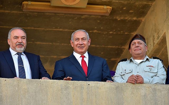 Le Premier ministre Benjamin Netanyahu (au centre), entouré, à gauche du ministre de la Défense Avigdor Liberman et du chef d'état-major Gadi Eizenkot lors d'une cérémonie pour les nouvelles recrues de l'armée israélienne., le 20 juin 2018;. (Crédit : Ariel Hermoni/Ministère de la Défense) Le Premier ministre Benjamin Netanyahu (au centre), entouré, à gauche du ministre de la Défense Avigdor Liberman et du chef d'état-major Gadi Eizenkot lors d'une cérémonie pour les nouvelles recrues de l'armée israélienne., le 20 juin 2018;. (Crédit : Ariel Hermoni/Ministère de la Défense)