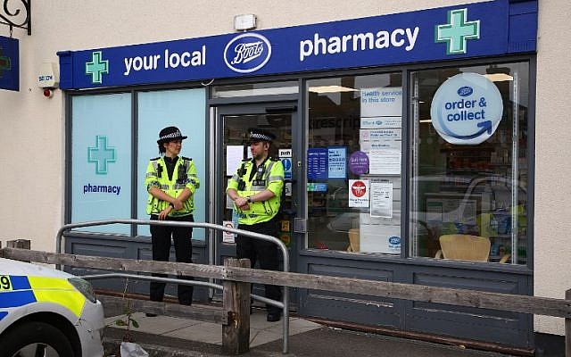 Des policiers devant une pharmacie à Amesbury, où deux personnes ont été retrouvée inconscientes, dans des circonstances encore floues d'un empoisonnement, le 4 juillet 2018. (Crédit : AFP / Geoff CADDICK)