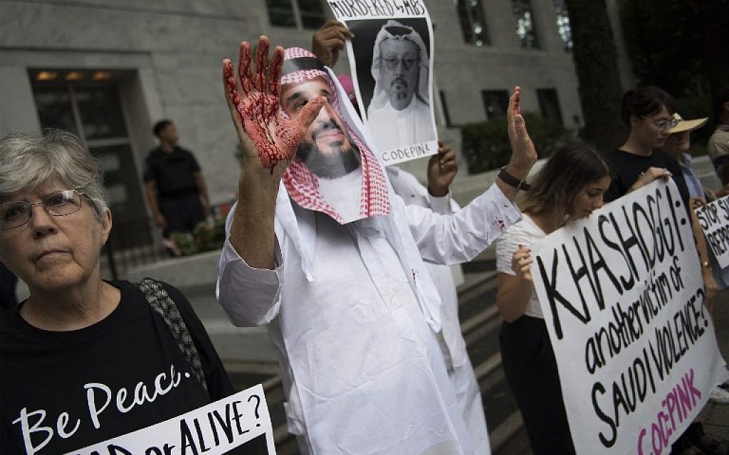 Un manifestant déguisé en prince saoudien Mohammed bin Salman (C), le visage ensanglanté, manifestait devant les locaux de l'ambassade saoudienne à Washington, le 8 octobre 2018, pour demander que justice soit rendue pour le journaliste égaré Jamal Khashoggi. (Crédit : Jim Watson / AFP)