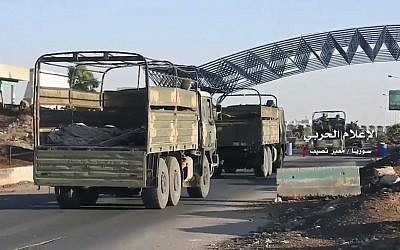 Convoy of Syrian military vehicles at Naseeb border crossing with Jordan, in the southern province of Daraa, Syria, July 7, 2018. (Syrian Central Military Media, via AP)