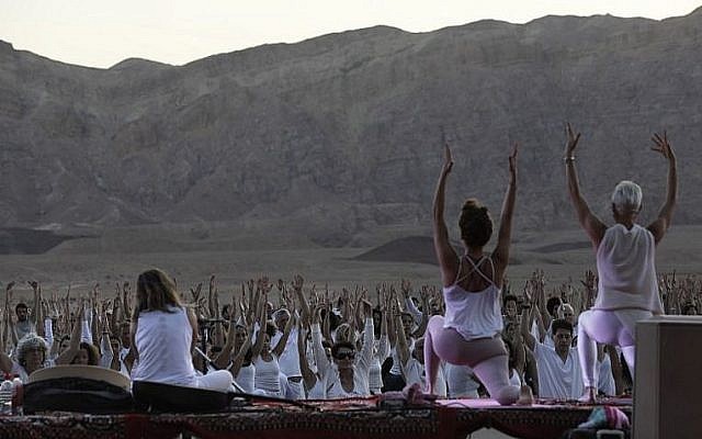 Des yogis, israéliens et étrangers, participent au festival annuel de yoga d'Arava dans le secteur des anciennes mines de cuivre dans la vallée de Timna, dans la région d'Arava, dans le sud d'Israël, le 2 novembre 2018 (Crédit : MENAHEM KAHANA / AFP)