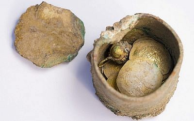 Le pot de pièces d'or et une boucle d'oreille découverts lors de fouilles archéologiques à Césarée, (Crédit : Caesarea Development Corporation)