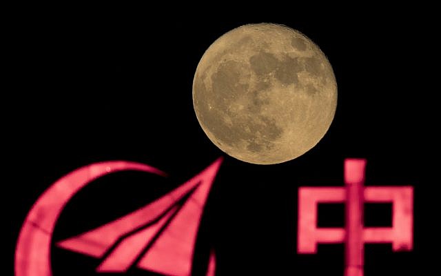 La super-lune s'élève sur le logo d'AVIC - ou Aviation Industry Corp, - compagnie d'état chargée des missions spatiales avec équipage en Chine, à Pékin, le 15 novembre 2016 (Crédit : AP Photo/Ng Han Guan) La super-lune s'élève sur le logo d'AVIC - ou Aviation Industry Corp, - compagnie d'état chargée des missions spatiales avec équipage en Chine, à Pékin, le 15 novembre 2016 (Crédit : AP Photo/Ng Han Guan)