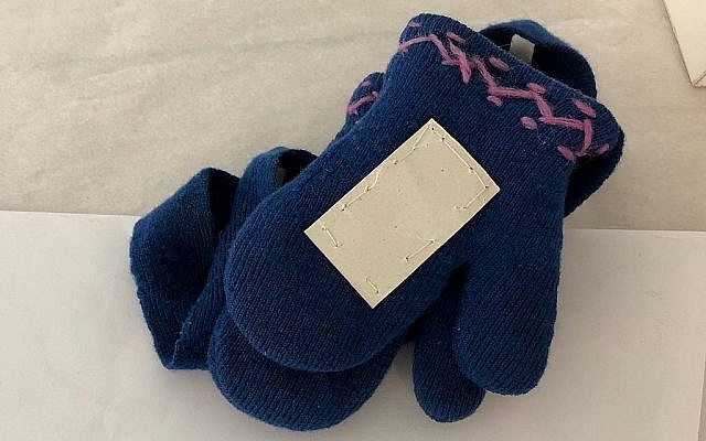 Une paire de gants en laine ayant  appartenu à Hinda Cohen, deux ans, assassinée à Auschwitz le 27 mars 1944 (Crédit : Amanda Borschel-Dan/Times of Israel)