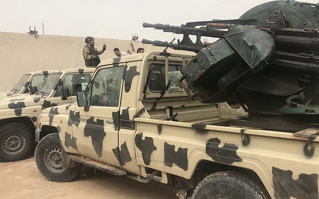 Des miliciens locaux appartenant à un groupe opposé à l'homme fort libyen Khalifa Haftar auprès de véhicules saisis aux forces de ces derniers sur une de leurs bases située à Zawiya, le 5 avril 2019 (Crédit : Mahmud TURKIA / AFP) Des miliciens locaux appartenant à un groupe opposé à l'homme fort libyen Khalifa Haftar auprès de véhicules saisis aux forces de ces derniers sur une de leurs bases située à Zawiya, le 5 avril 2019 (Crédit : Mahmud TURKIA / AFP)