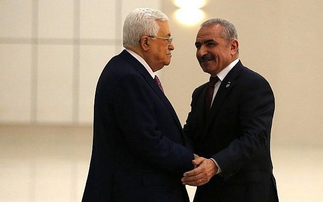Le président de l'Autorité palestinienne Mahmoud Abbas, à gauche, serre la main du nouveau Premier ministre Mohammad Shtayyeh dans la ville de Ramallah,; en Cisjordanie, le 13 avril 2019 (Crédit : Abbas Momani/AFP) Le président de l'Autorité palestinienne Mahmoud Abbas, à gauche, serre la main du nouveau Premier ministre Mohammad Shtayyeh dans la ville de Ramallah,; en Cisjordanie, le 13 avril 2019 (Crédit : Abbas Momani/AFP)