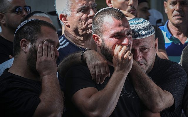 Des amis et des parents effondrés lors des funérailles de Moshe Agadi, 58 ans, tué par des éclats d'obus après que sa maison a été directement atteinte par une roquette lancée sur Ashkelon, au sud d'Israël, le 5 mai 2019, depuis la bande de Gaza. (Noam Rivkin Fenton/Flash90) Des amis et des parents effondrés lors des funérailles de Moshe Agadi, 58 ans, tué par des éclats d'obus après que sa maison a été directement atteinte par une roquette lancée sur Ashkelon, au sud d'Israël, le 5 mai 2019, depuis la bande de Gaza. (Noam Rivkin Fenton/Flash90)