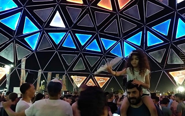 Des gens dansent dans l'un des nombreux endroits accueillant un DJ au village de l'Eurovision, au parc Charles Clore de Tel Aviv, le 16 mai 2019. (Crédit : Melanie Lidman/Times of Israel) Des gens dansent dans l'un des nombreux endroits accueillant un DJ au village de l'Eurovision, au parc Charles Clore de Tel Aviv, le 16 mai 2019. (Crédit : Melanie Lidman/Times of Israel)