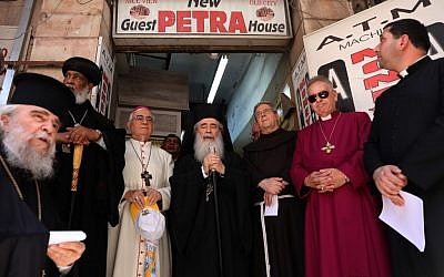 Le patriarche grec-orthodoxe de Jérusalem Theophilos III, au centre, avec le gardien franciscain en Terre sainte, Frère Francesco Patton, au centre-droit, et d'autres responsables d'église pendant une prière œcuménique à l'entrée du Petra Hotel, porte de Jaffa, dans la Vieille Ville de Jérusalem, le 11 juin 2019 (Crédit : GALI TIBBON / AFP) Le patriarche grec-orthodoxe de Jérusalem Theophilos III, au centre, avec le gardien franciscain en Terre sainte, Frère Francesco Patton, au centre-droit, et d'autres responsables d'église pendant une prière œcuménique à l'entrée du Petra Hotel, porte de Jaffa, dans la Vieille Ville de Jérusalem, le 11 juin 2019 (Crédit : GALI TIBBON / AFP)