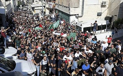 Illustration : Des Palestiniens portent le corps de Mohammed Obeid lros de ses funérailles à Jérusalem-Est, dans le quartier d'Issawiya le 1er juillet 2019. (Crédit : AP Photo/Mahmoud Ilean)