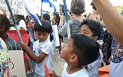 Deux garçons philippins lors d'une manifestation contre les expulsions à Tel Aviv, le 24 juin 2019. (Melanie Lidman/Times of Israël)