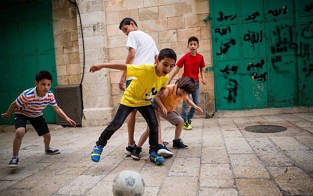 De jeunes enfants arabes jouent au football dans les rues du quartier musulman de la Vieille ville de Jérusalem, le 8 avril 2016.(Corinna Kern/Flash90) De jeunes enfants arabes jouent au football dans les rues du quartier musulman de la Vieille ville de Jérusalem, le 8 avril 2016.(Corinna Kern/Flash90)