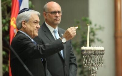Le président chilien Sebastian Pinera allume une bougie de Hanoukka lors d'une cérémonie le 27 décembre 2019, au palais de La Moneda à Santiago. (Autorisation du gouvernement chilien) Le président chilien Sebastian Pinera allume une bougie de Hanoukka lors d'une cérémonie le 27 décembre 2019, au palais de La Moneda à Santiago. (Autorisation du gouvernement chilien)