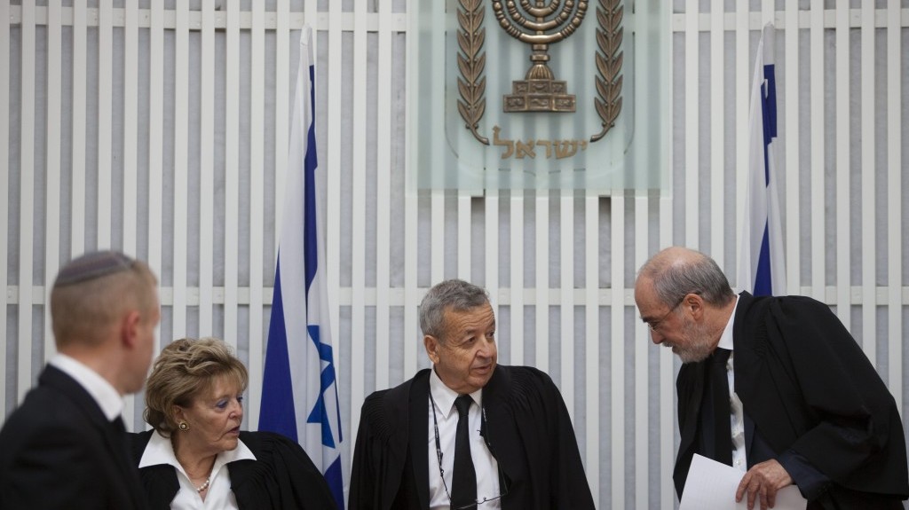 Vice Supreme Court President Eliezer Rivlin (center) flanked by Supreme Court President Asher Grunis (right) and Judge Edna Arbel (left) at a ceremony in honor of Rivlin's retirement from the Supreme Court on Thursday (photo credit: David Vaaknin/Flash90)