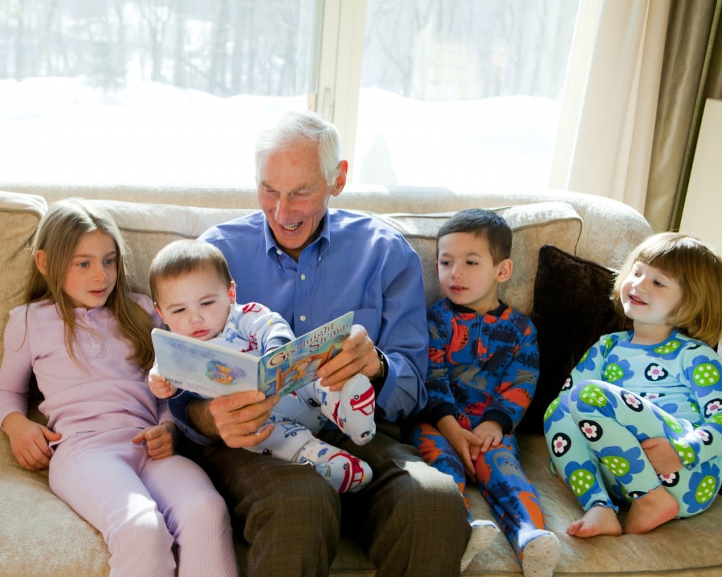 Harold Grinspoon, the founder of PJ Library, reads one of the program's books with a gaggle of children. (photo credit: PJ Library/JTA)