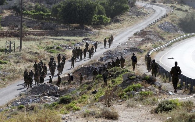 Des soldats israéliens en train de se diriger vers le village de Halhul, près de Hébron (Crédit : AFP/HAZEM BADER) Des soldats israéliens en train de se diriger vers le village de Halhul, près de Hébron (Crédit : AFP/HAZEM BADER)