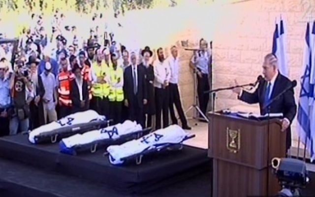 Les corps des trois adolescents enveloppés dans des drapeaux d'Israël (Crédit : capture d'écran Deuxième chaîne)