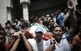 A Gaza, aux obsèques de la femme et des fils de Mohammed Deif, la foule crie vengeance, le 20 août 2014. (Crédit Thomas Coex/AFP)