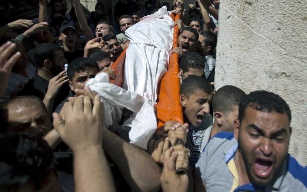 Des Palestiniens portent le corps de l'un des trois commandants du Hamas tués par Tsahal -  l'enterrement s'est déroulé dans le sud de la bande de Gaza à Rafah, le 21 août, 2014 (Crédit : AFP Photo / Mahmud Hams)