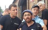 Rabbi Rafi Ostroff détenu par des gardes de sécurité à Auschwitz-Birkenau 1 Août 2014. (Crédit : La page Facebook de Rafi Ostroff)