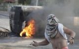 Un Palestinien masqué jette des pierres à la police israélienne à Jérusalem-Est - 30 octobre 2014 (Crédit : AFP/ Ahmad Gharabli)