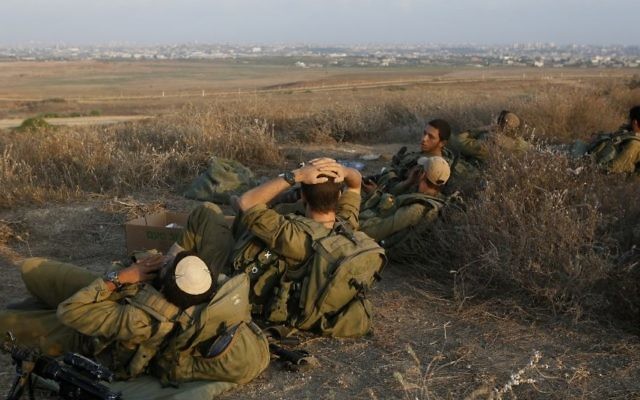 Des soldats israéliens stationnés à la frontière de la bande de Gaza en août 2014 (Crédit : Miriam Alster/Flash90)
