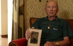 Stefan Weiss, avec une photo de sa famille, dans sa chambre à Reuth. (Crédit : Eldad Rafaeli)